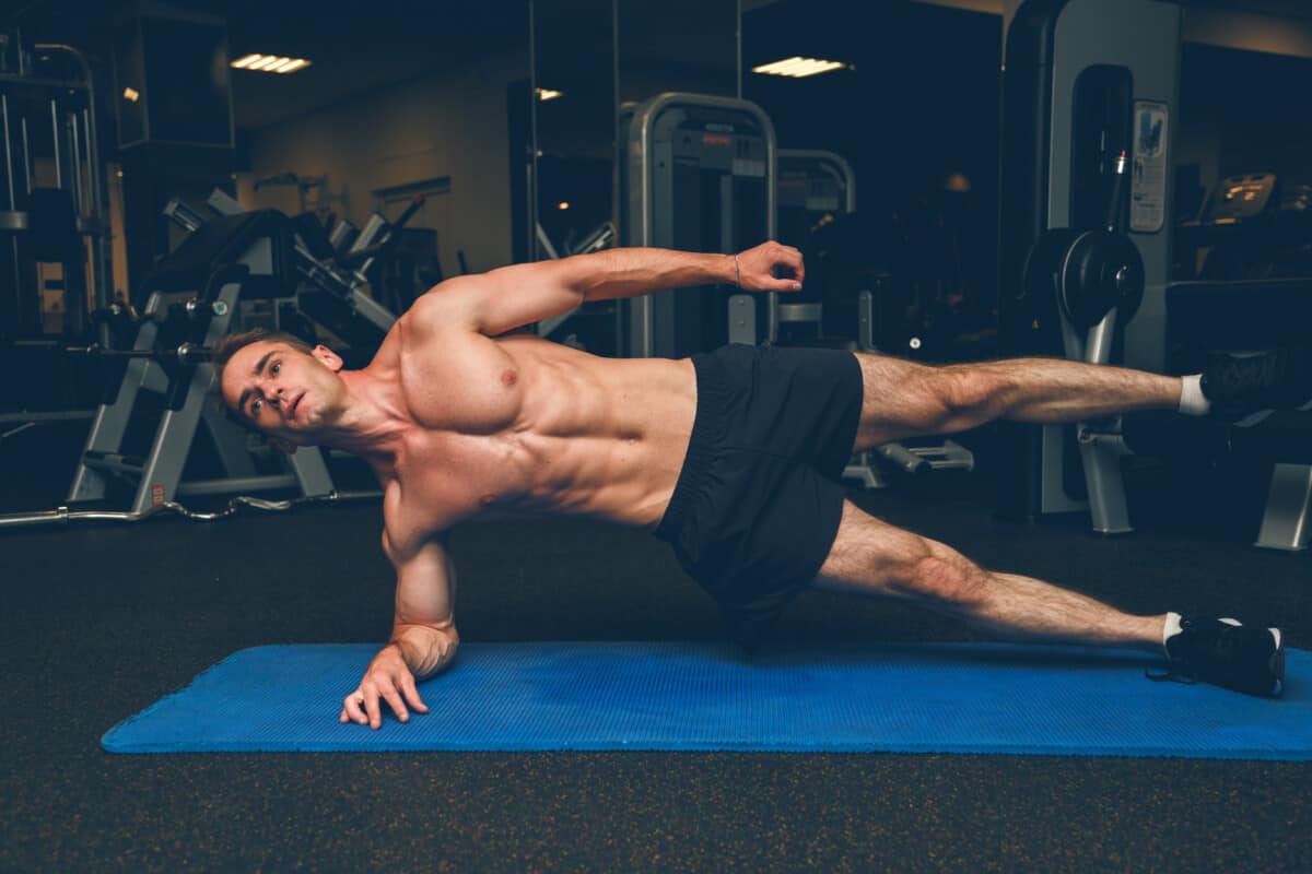 fit man side plank exercise with leg raise what to do to lose love handles